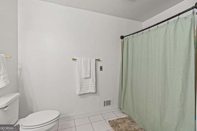 bathroom with baseboards, visible vents, toilet, and tile patterned floors