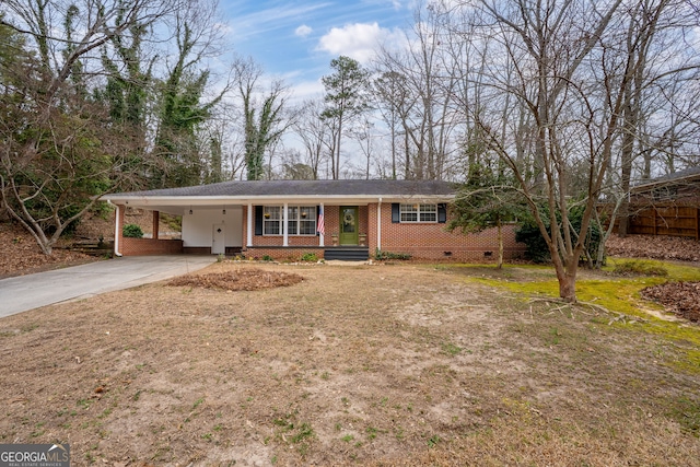 ranch-style house featuring crawl space, an attached carport, concrete driveway, and brick siding