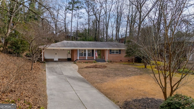 ranch-style home with brick siding, a porch, concrete driveway, crawl space, and a carport