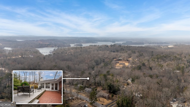 drone / aerial view featuring a forest view and a water view