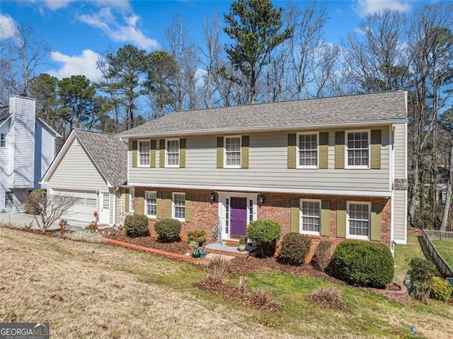 view of front of property featuring brick siding, a front lawn, and an attached garage