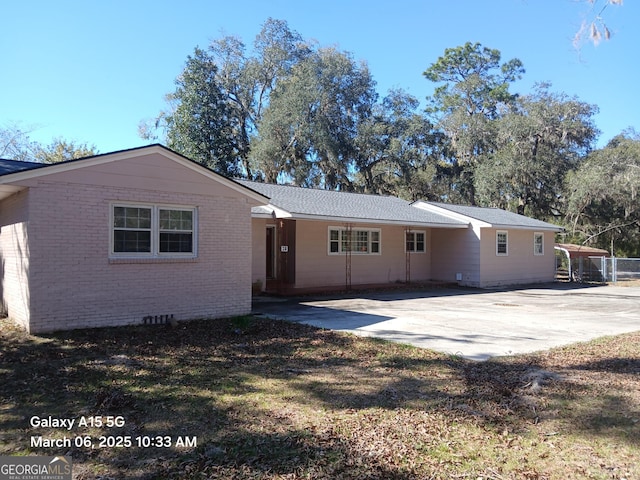 back of house with crawl space and brick siding