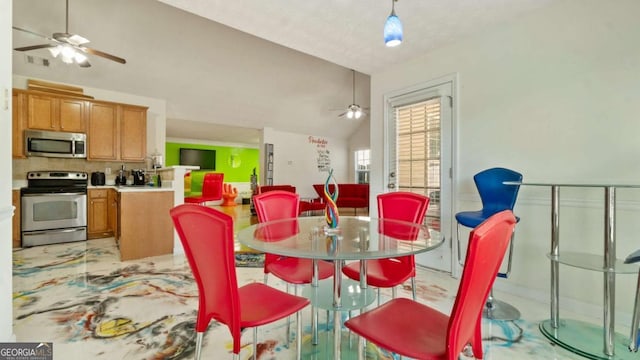 dining space featuring lofted ceiling, ceiling fan, and visible vents