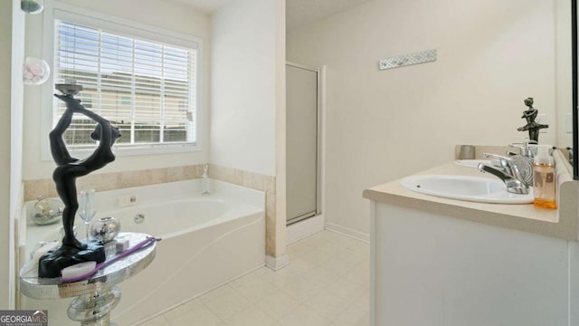 full bathroom featuring vanity, a shower stall, a bath, and baseboards