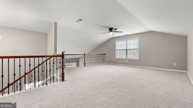 additional living space with lofted ceiling, ceiling fan, visible vents, and carpet flooring