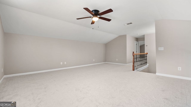 additional living space with lofted ceiling, visible vents, carpet floors, and baseboards
