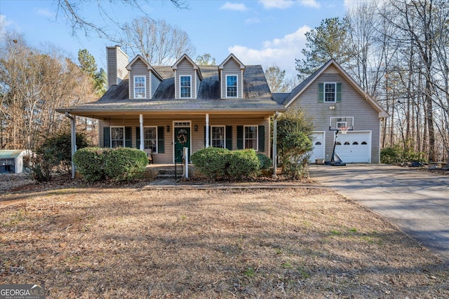 view of front of property featuring a garage, covered porch, a chimney, and concrete driveway