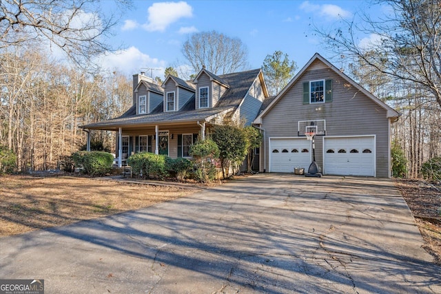 cape cod-style house featuring a porch, driveway, and a garage