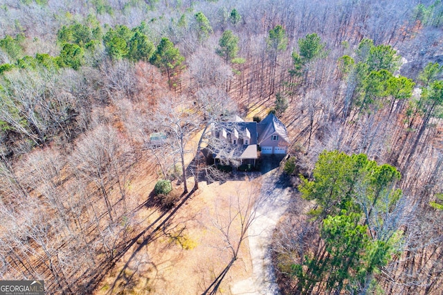 birds eye view of property with a forest view