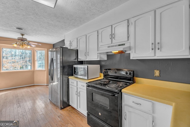 kitchen featuring visible vents, stainless steel appliances, light wood-type flooring, under cabinet range hood, and white cabinetry