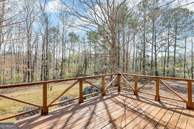 wooden terrace with a view of trees