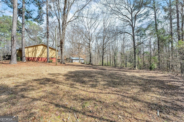 view of yard with a wooded view