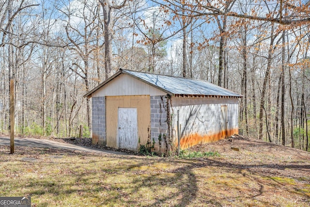 view of shed with a wooded view