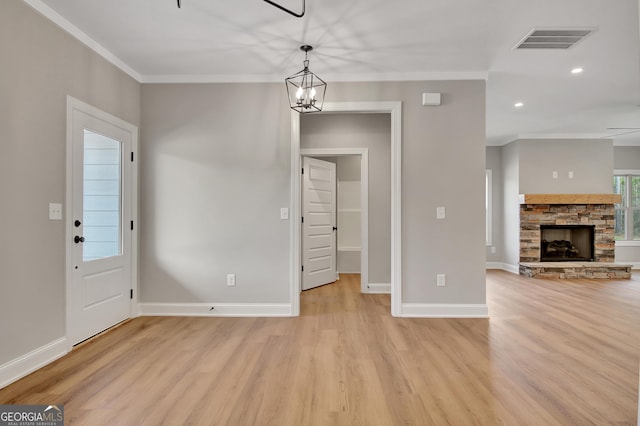 interior space with ornamental molding, visible vents, and light wood finished floors