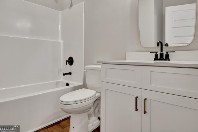 bathroom featuring shower / bathing tub combination, vanity, toilet, and wood finished floors