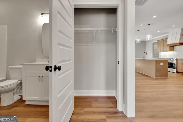 closet with a sink and visible vents