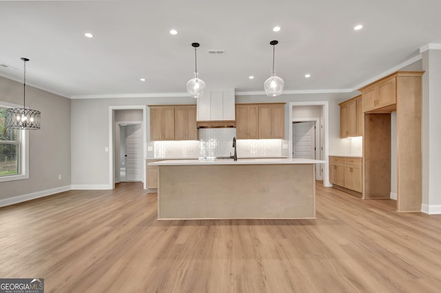 kitchen with ornamental molding, light countertops, visible vents, and light wood finished floors