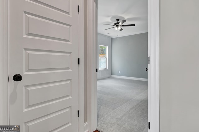 corridor featuring carpet floors and baseboards