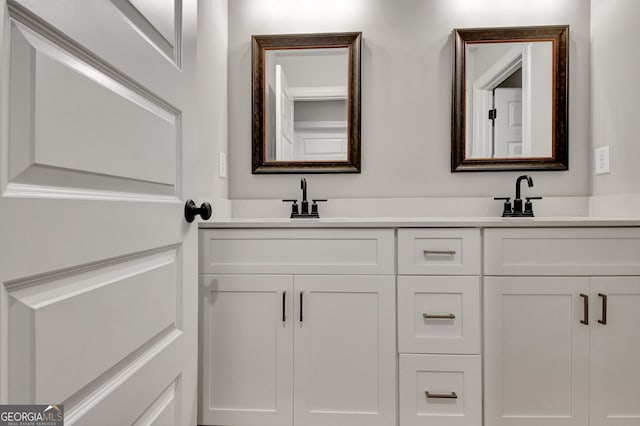 bathroom with a sink and double vanity