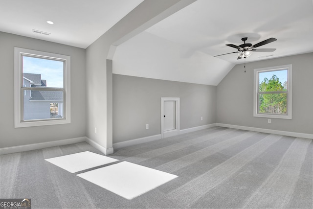 bonus room featuring lofted ceiling, carpet flooring, plenty of natural light, and baseboards