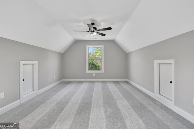 bonus room with lofted ceiling, carpet, a ceiling fan, and baseboards