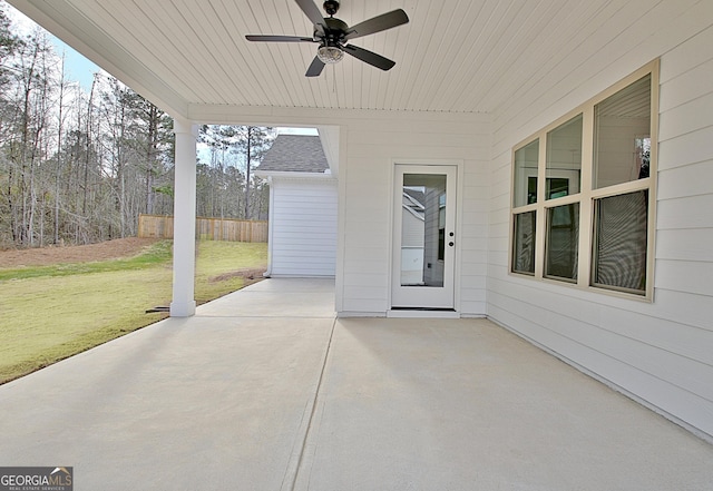 view of patio with ceiling fan and fence