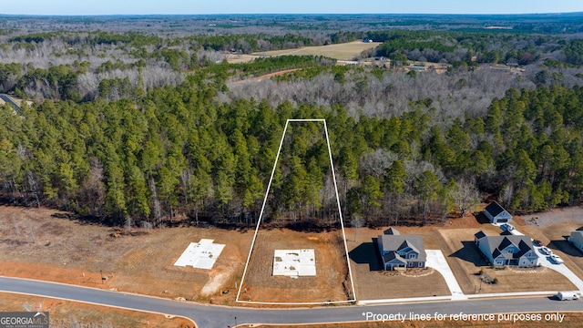 bird's eye view featuring a forest view