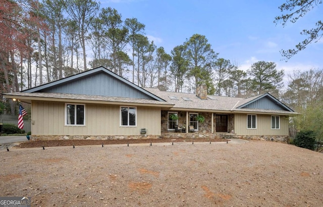 single story home with a chimney and roof with shingles