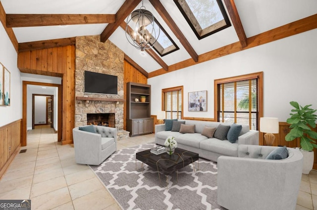 living area with high vaulted ceiling, light tile patterned floors, a stone fireplace, a chandelier, and beamed ceiling