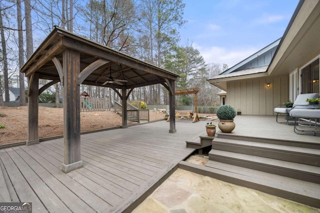 wooden deck with fence, a ceiling fan, and a gazebo