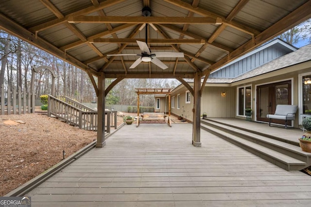 wooden terrace featuring ceiling fan, a gazebo, fence, and a jacuzzi