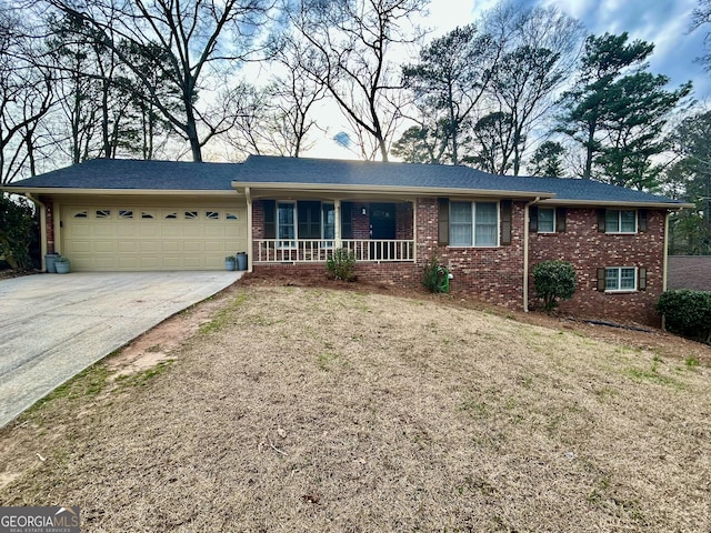 ranch-style home featuring a garage, concrete driveway, and brick siding