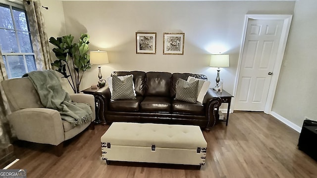 living area featuring wood finished floors and baseboards