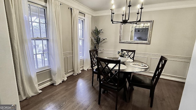 dining room with a decorative wall, a wainscoted wall, a notable chandelier, ornamental molding, and dark wood-style floors