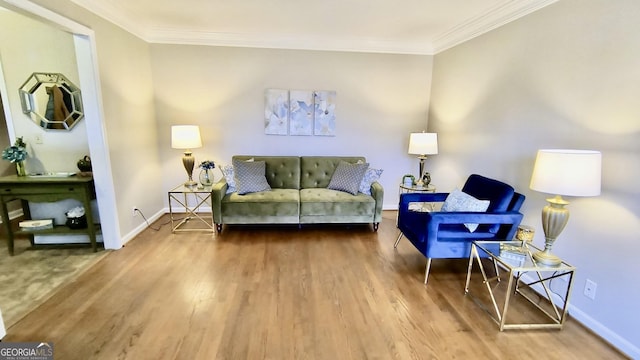 living room featuring crown molding, baseboards, and wood finished floors