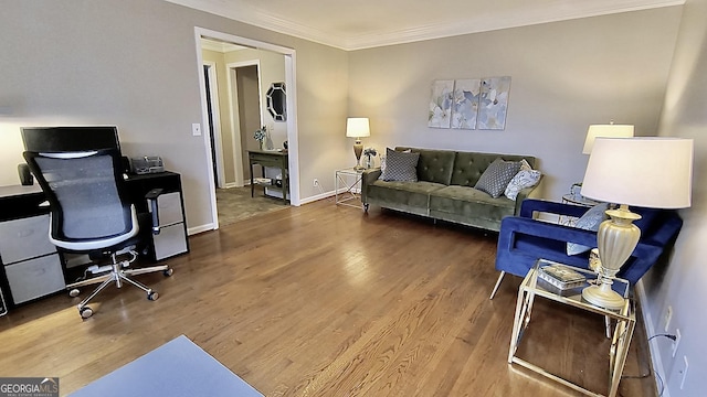 office space featuring baseboards, ornamental molding, and wood finished floors