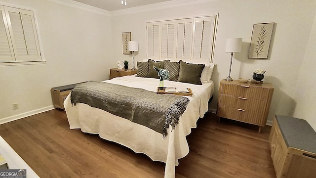 bedroom featuring crown molding, baseboards, and wood finished floors