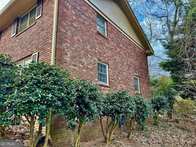 view of side of property with brick siding