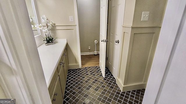 bathroom featuring baseboards, vanity, and tile patterned floors