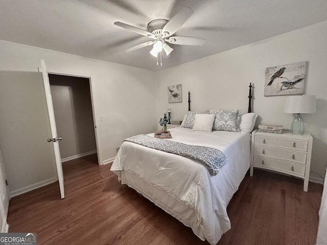 bedroom with wood finished floors, a ceiling fan, and baseboards