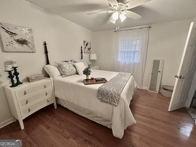 bedroom featuring ceiling fan and dark wood-style flooring