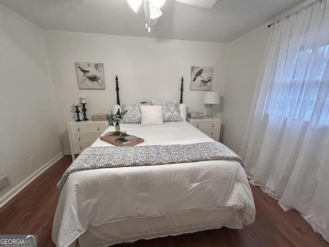 bedroom featuring ceiling fan, baseboards, and wood finished floors