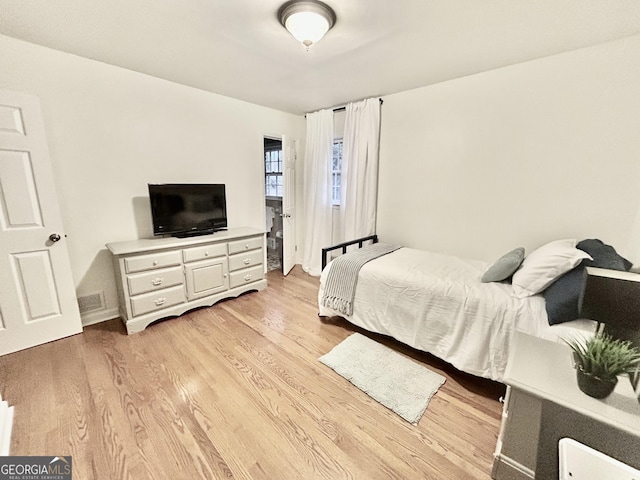 bedroom with visible vents and light wood-style floors