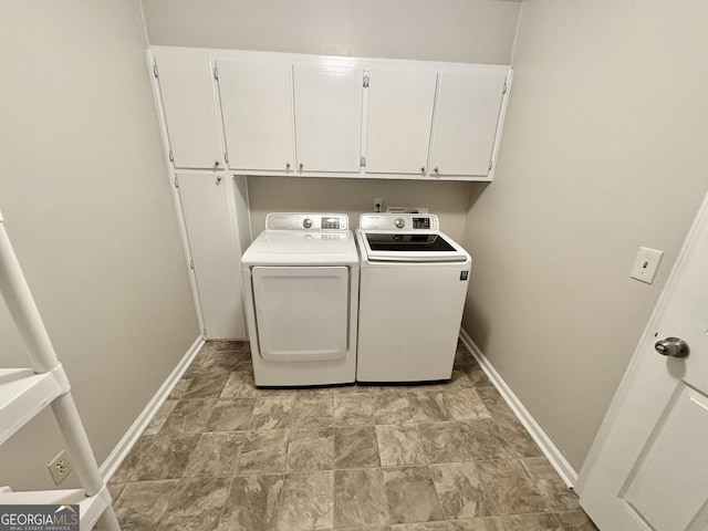 clothes washing area with cabinet space, baseboards, and separate washer and dryer