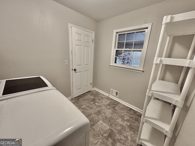 laundry room featuring laundry area, baseboards, visible vents, and washer / dryer