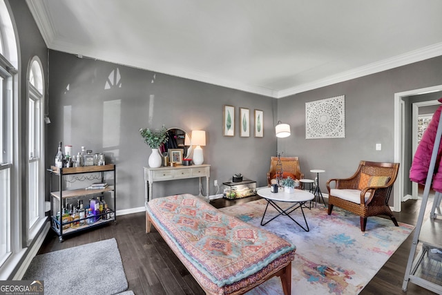 living area featuring baseboards, ornamental molding, and dark wood-style flooring