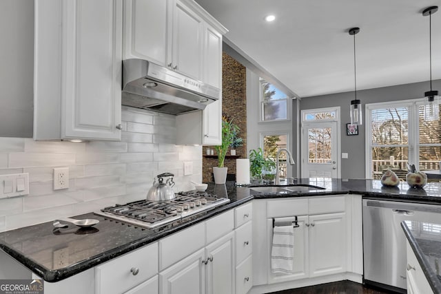 kitchen with appliances with stainless steel finishes, a sink, white cabinetry, and under cabinet range hood