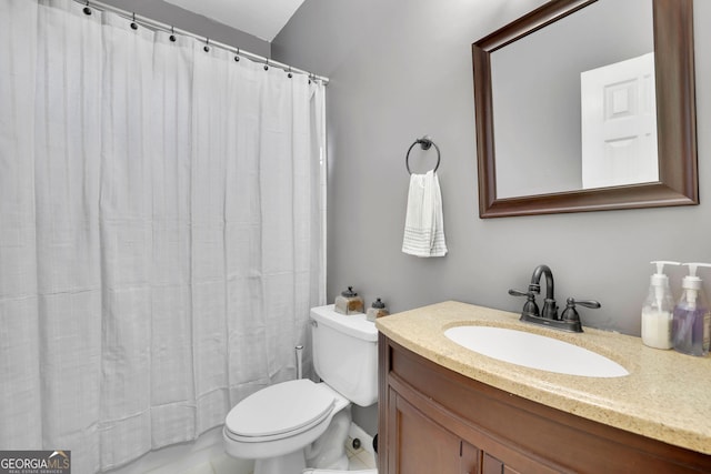 bathroom featuring curtained shower, vanity, and toilet