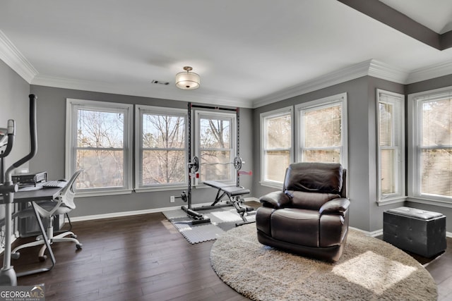 sitting room featuring dark wood-style floors, crown molding, visible vents, and baseboards