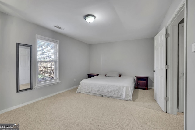 bedroom with carpet floors, baseboards, and visible vents